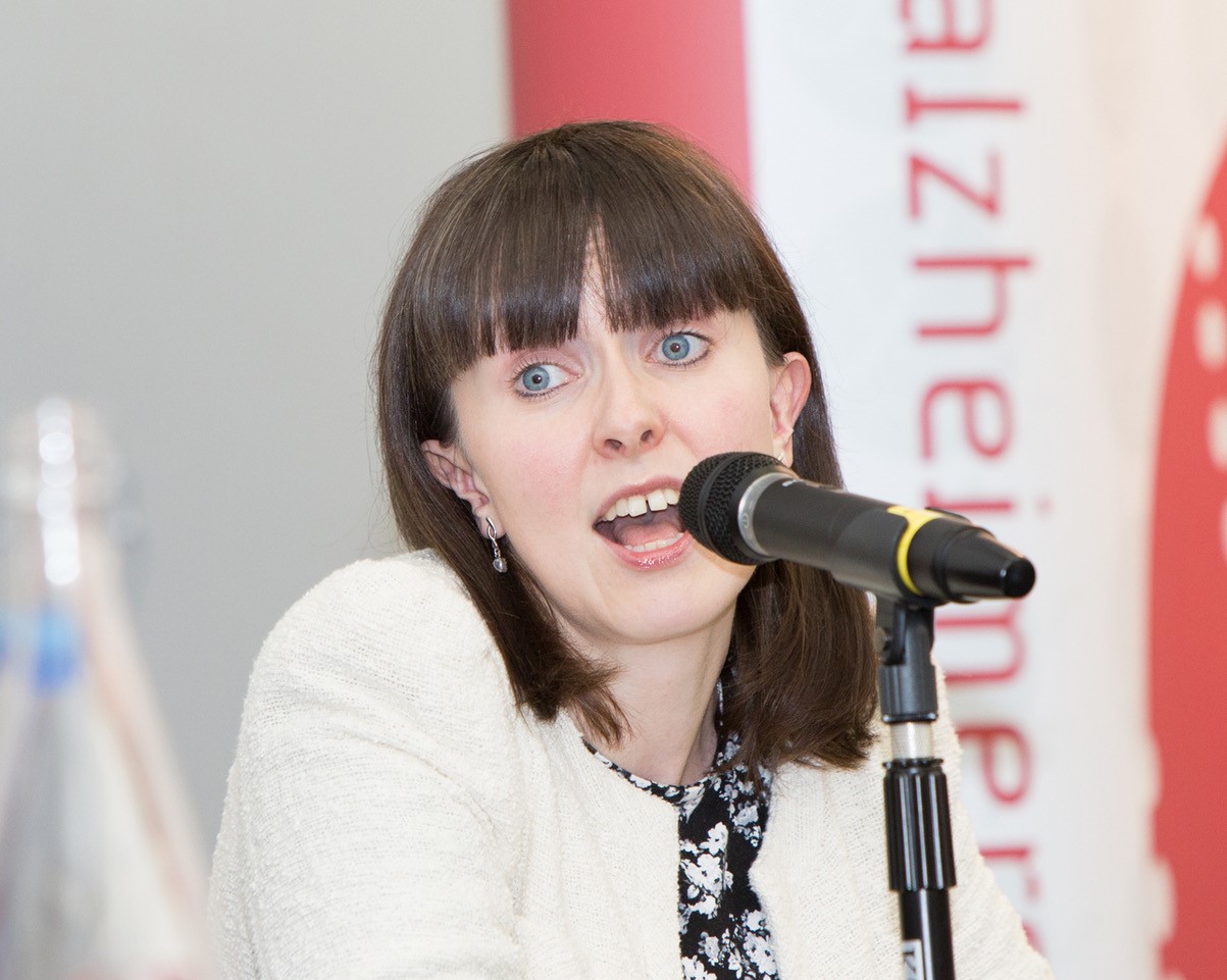 Woman talking in to a microphone