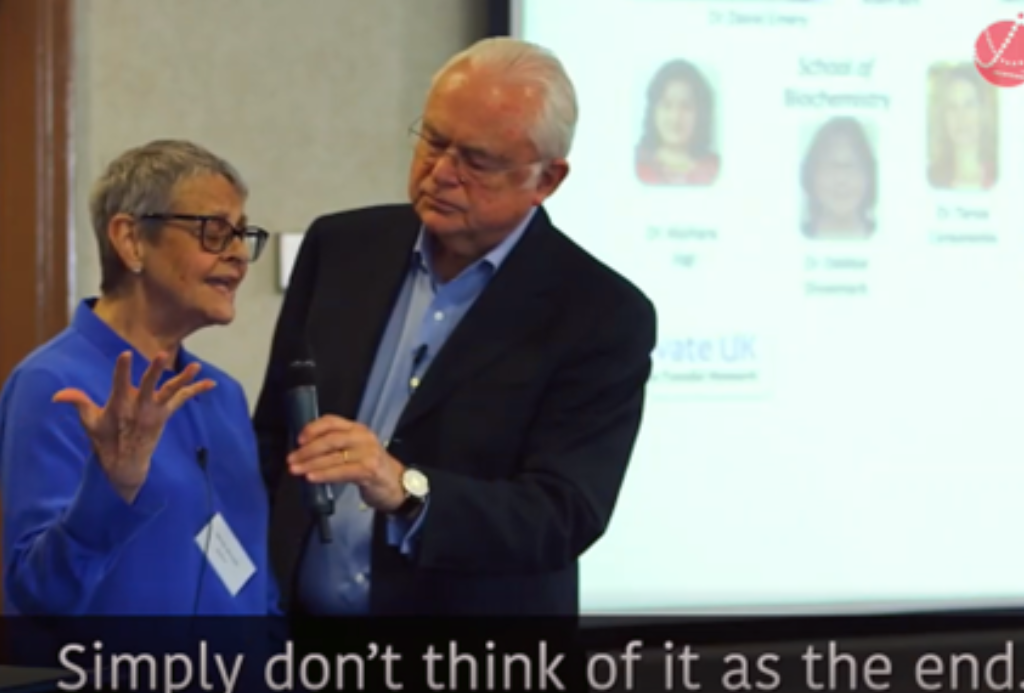 Wendy Mitchell is stood next to a man holding a microphone and talking.