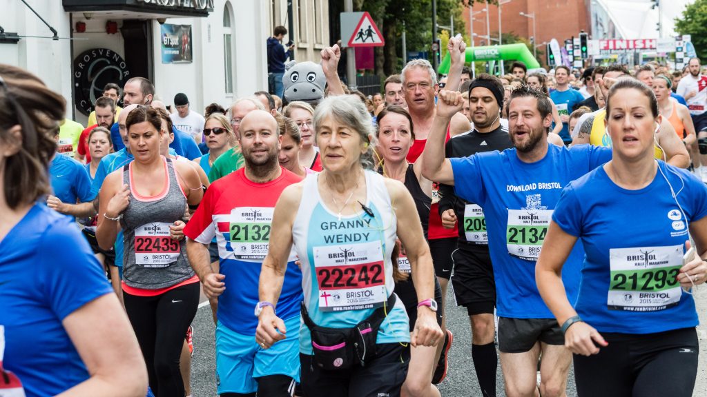 A road filled with runners as the start of a race in Bristol city centre.