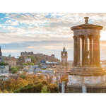 A landscape photo of Edinburgh on a sunny day. Lots of landmarks including Edinburgh castle are in the photo.