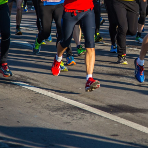 Lots of runners legs taking part in a race, you cannot see above their thighs.