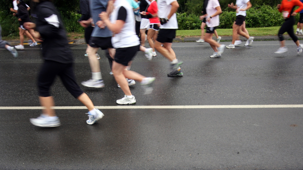 Lots of runners legs taking part in a race, you cannot see above their thighs.