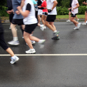 Lots of runners legs taking part in a race, you cannot see above their thighs.
