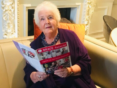 Stephanie Cole is reading the BRACE magazine.