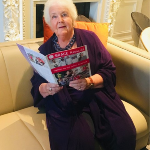 Stephanie Cole is reading the BRACE magazine.