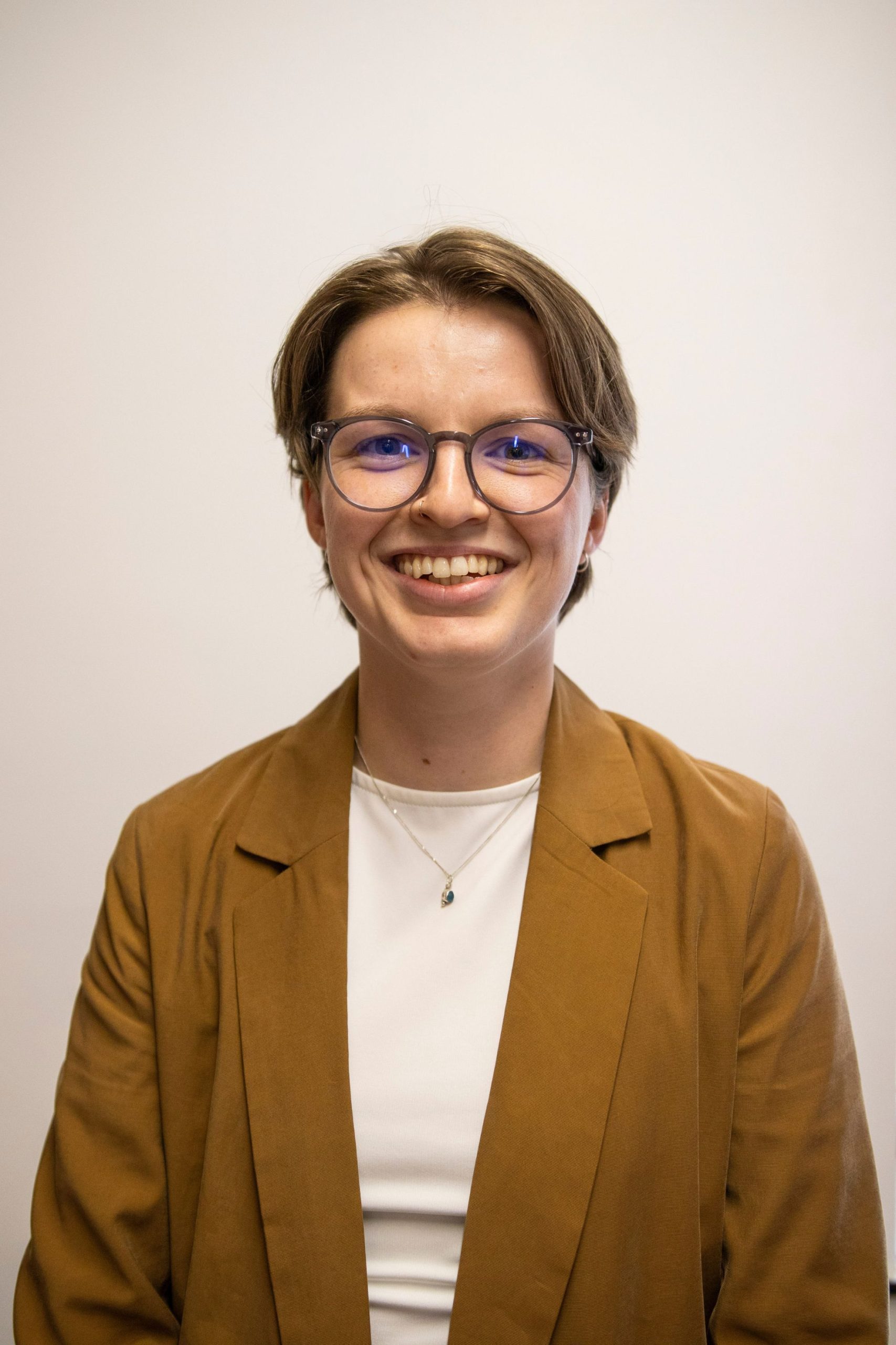 A headshot of Liberty Pring, a white woman in her 20s with short brown hair.