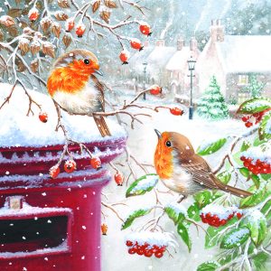 A snowy scene, with two robins on branches next to the top of a red traditional post box.