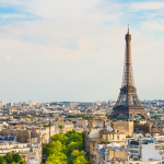 A landscape view of Paris, with the Eiffel tower in the background.