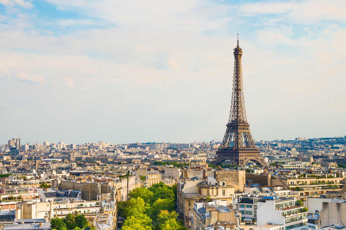 A landscape view of Paris, with the Eiffel tower in the background.