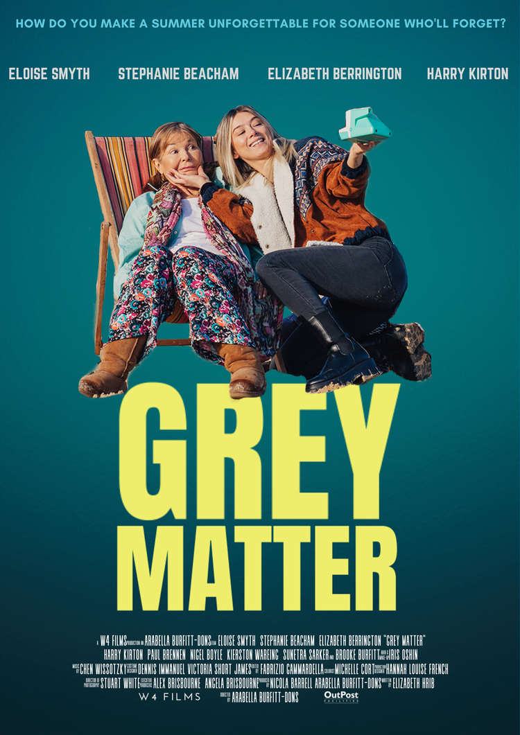 A poster for the film 'Grey Matter' featuring 2 women taking a photo and smiling.