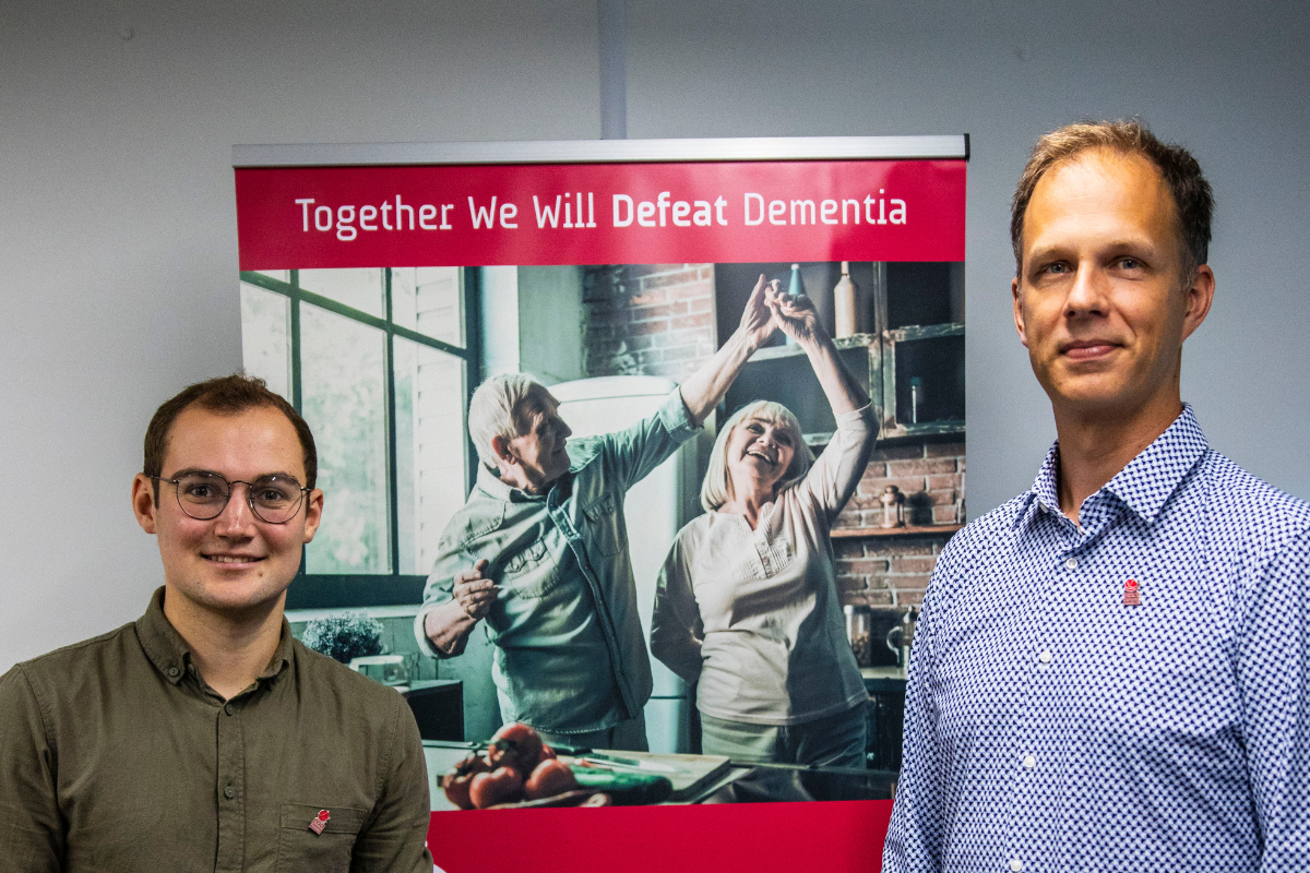 PhD student Oliver Hermann and researcher George Stothart standing next to a BRACE banner.