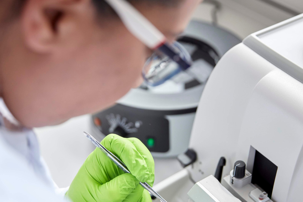 Why we fight appeal 1 hour of research A scientist in a lab coat looking at a slide