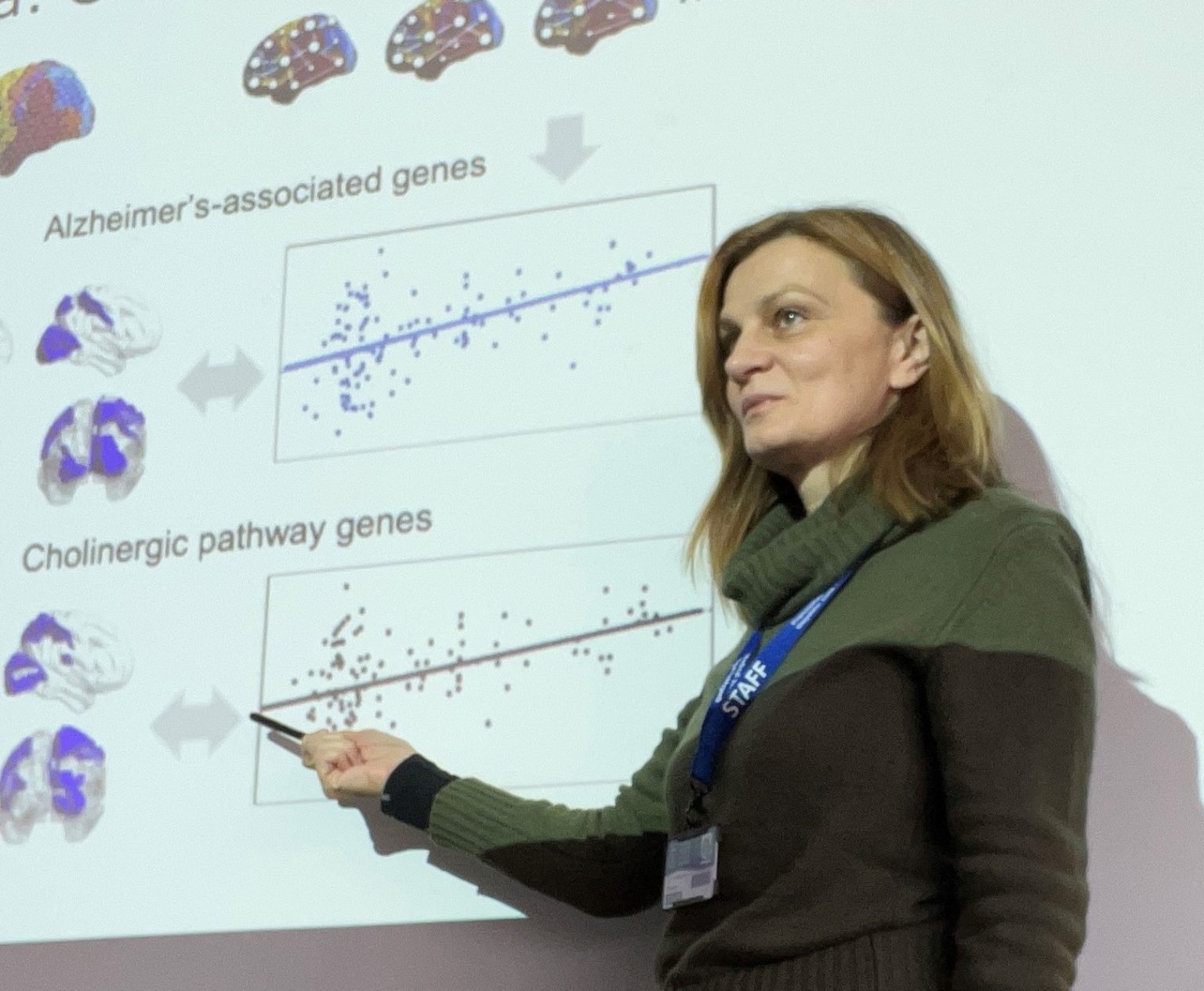 Dr Vesna Vuksanovic stands in front of a presentation displaying the results of recent research funded by BRACE Dementia Research. Dr Vuksanovic is a senior lecturer in imaging at Swansea University, and is developing new neuroimaging techniques to diagnose and understand dementia