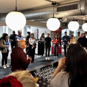 A bar filled with people, in the background is a BRACE banner and a person from BRACE is addressing the crowd.