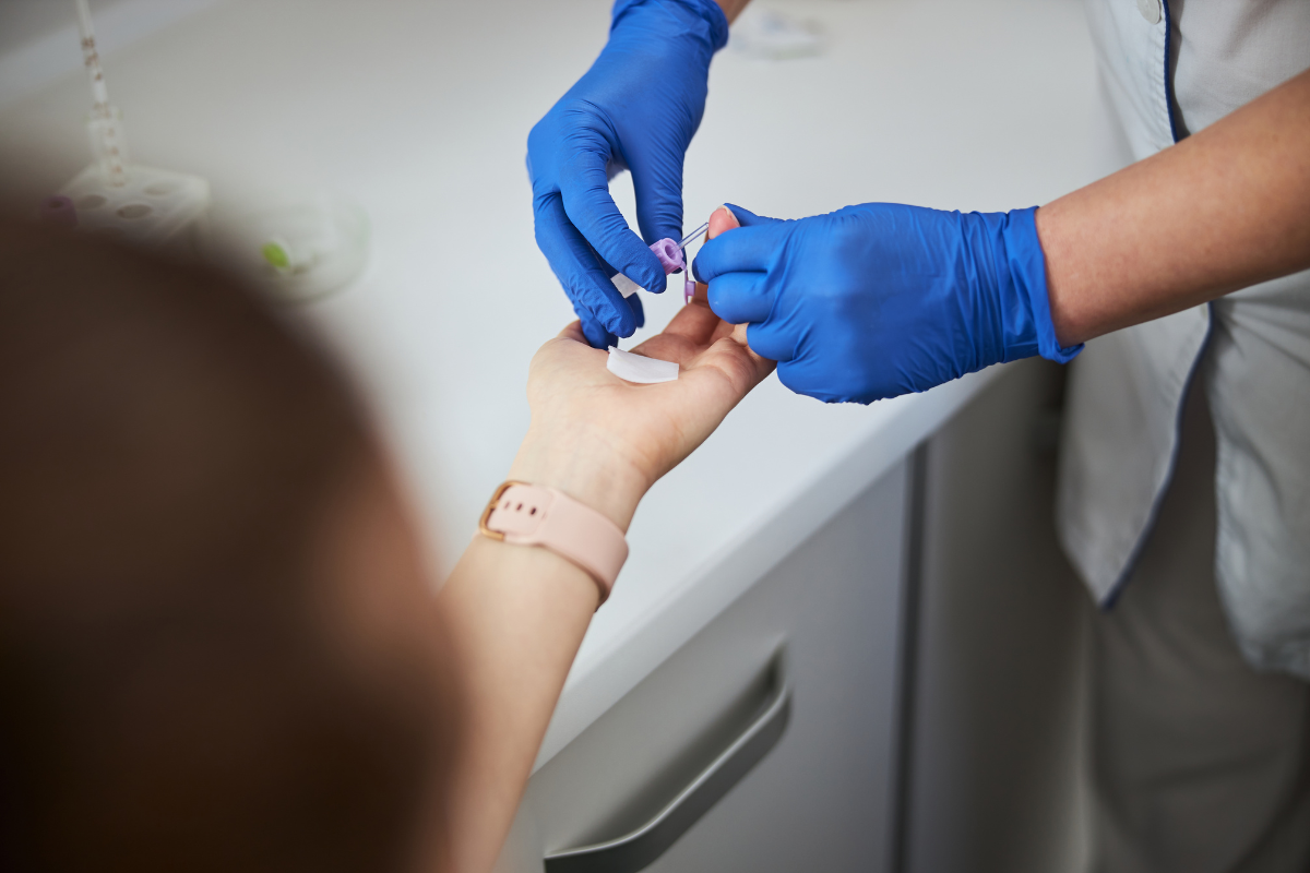 A finger-prick blood test being conucted