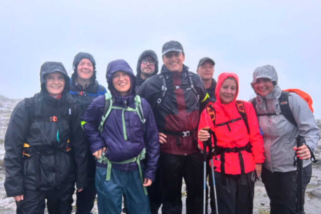 Signature staff on the top of a hill after hiking