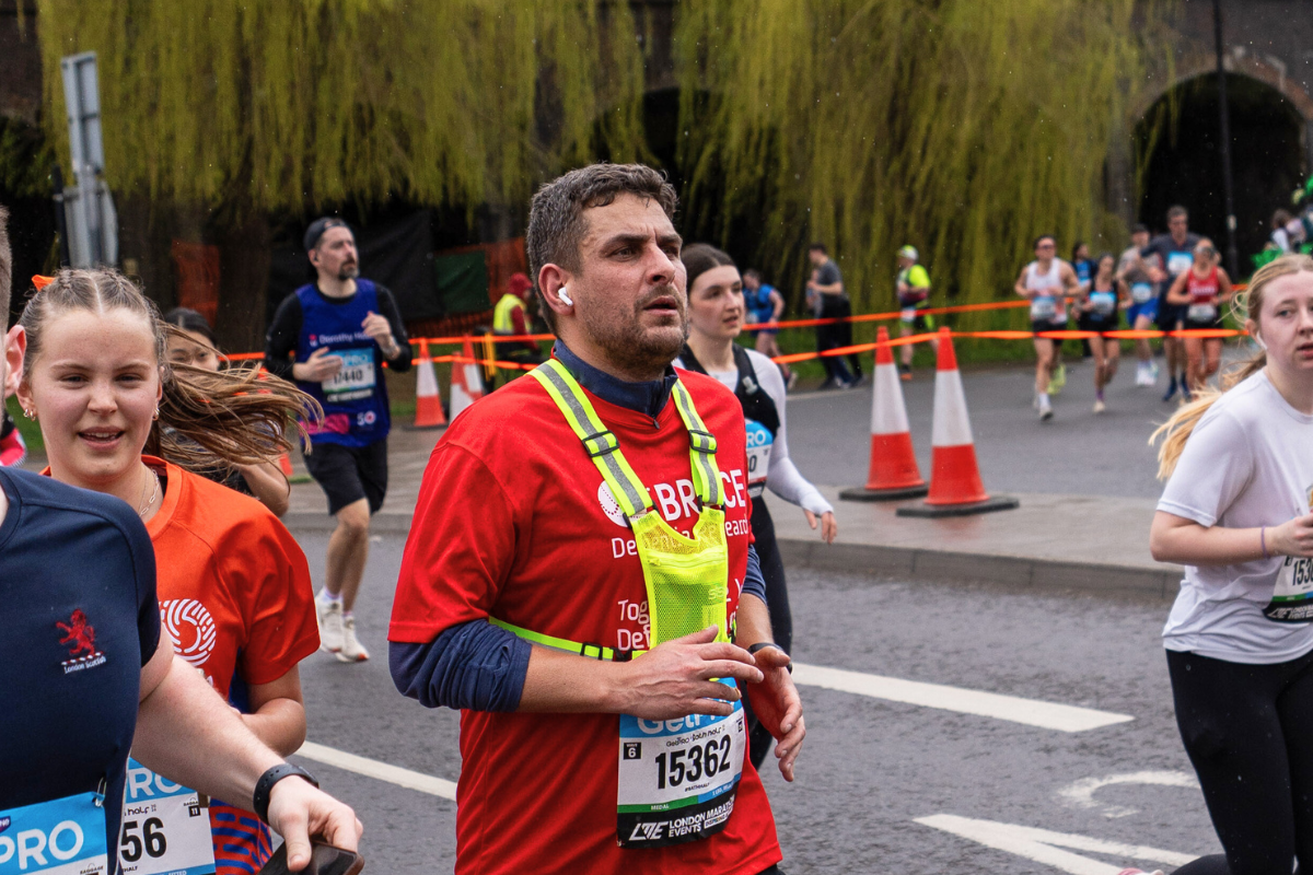 A BRACE runner wearing red a BRACE running top at the Bath Half Marathon.