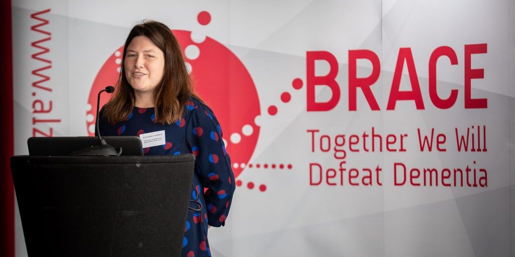 2019 Dr Coulthard conference Dr Coulhard stood up to a podium with a BRACE banner behnd her.