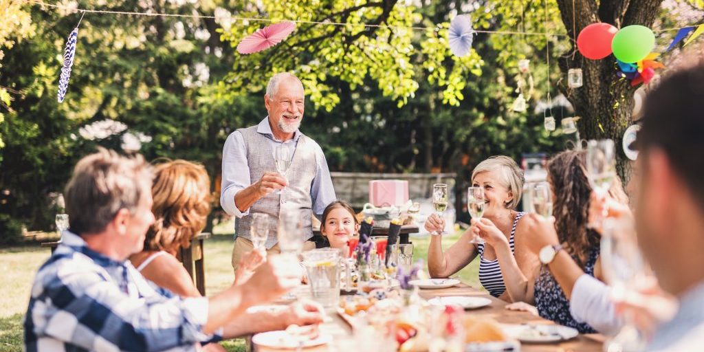 Family sat around a large table celebrating.